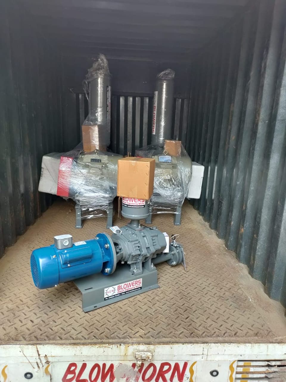 Two AEW root blowers packed and loaded in shipping container with new direct-drive unit