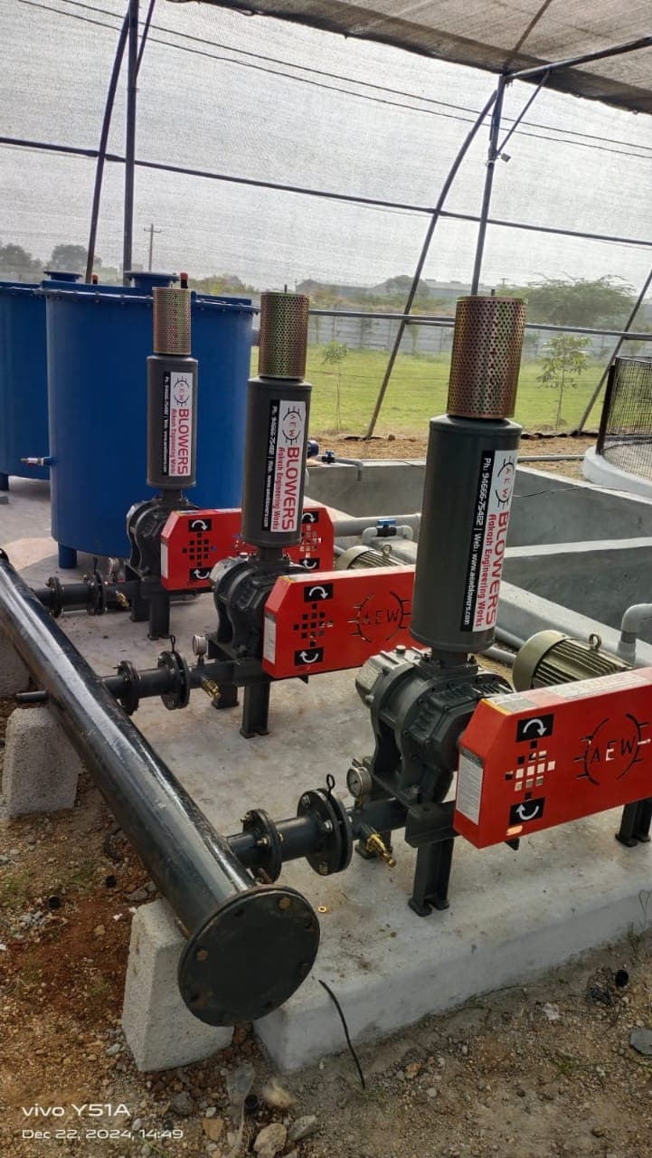 Three AEW root blowers installed at aquaculture pond site with aeration piping