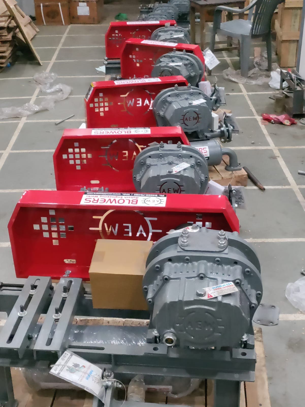 Five AEW root blowers lined up in workshop awaiting dispatch