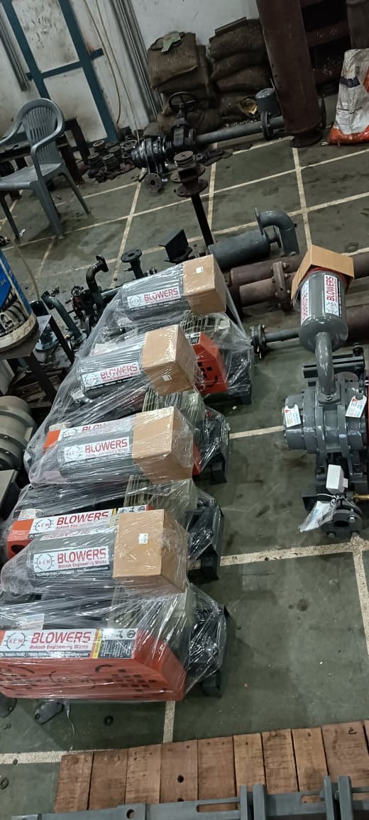 Five AEW root blowers on wooden pallets in assembly workshop