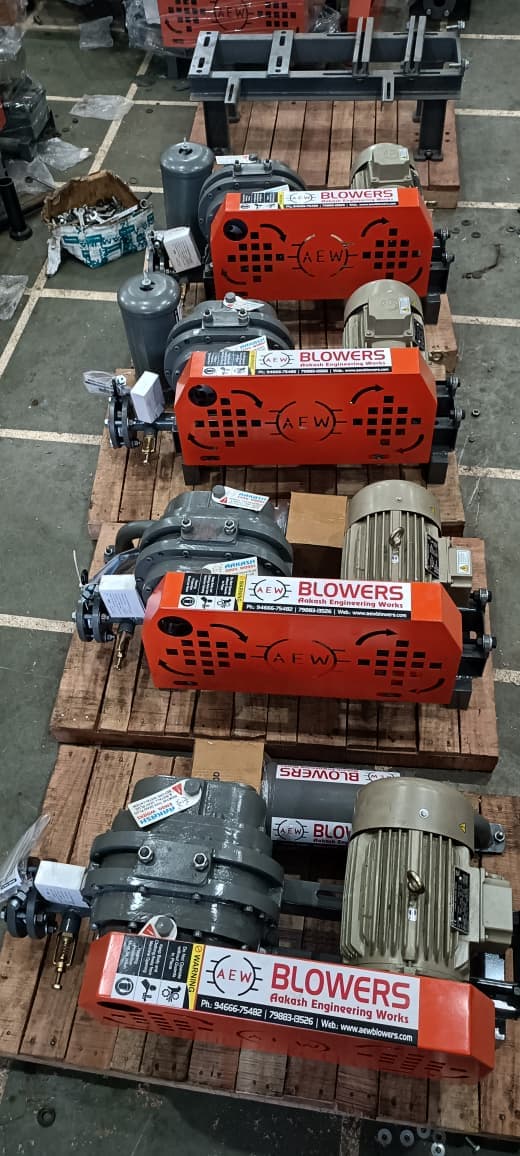 Multiple AEW root blowers arranged in rows on workshop floor